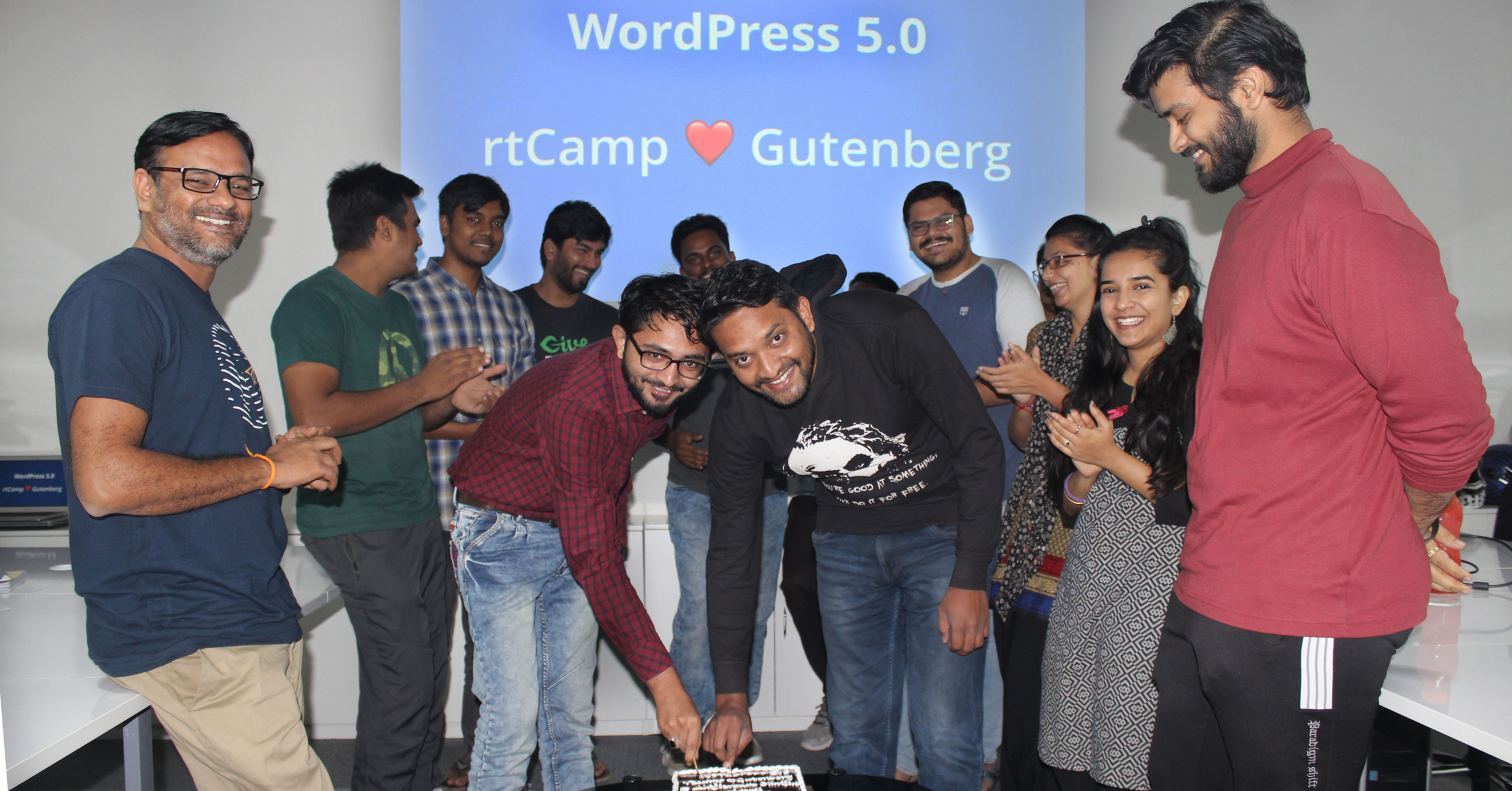 rtCampers celebrating the release of WordPress 5.0 with the traditional cake cutting ceremony.